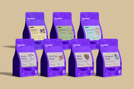 Line-up of BrewBuds Club coffee bags showing different blends and packaging colours.
